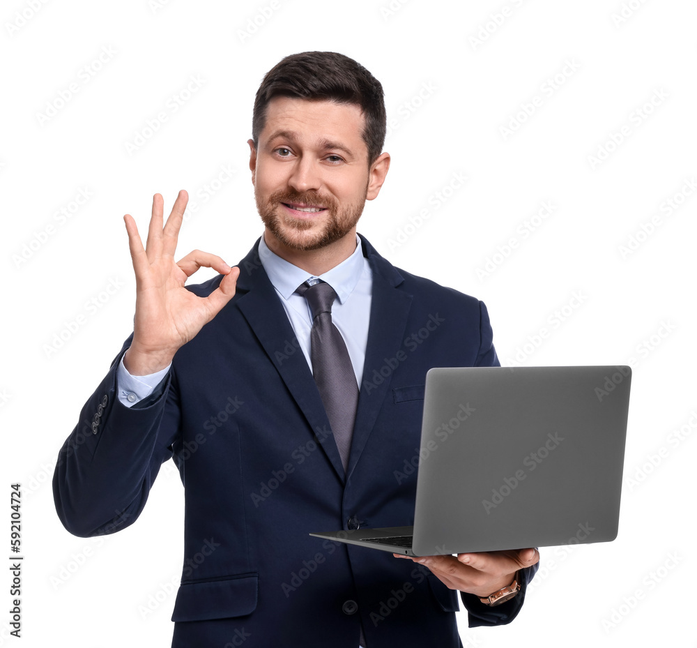 Handsome bearded businessman in suit with laptop showing OK gesture on white background Handsome bearded businessman in suit with laptop showing OK gesture on white background