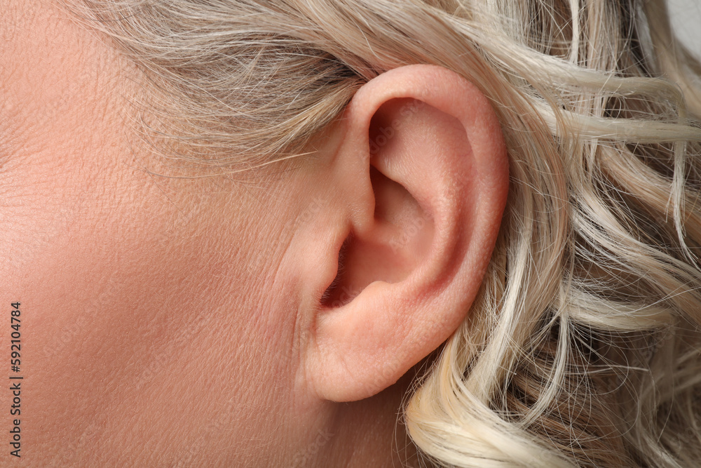 Closeup view of woman, focus on ear Closeup view of woman, focus on ear