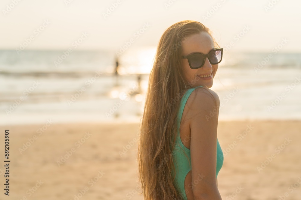 Beautiful woman in bikini on the beach enjoying her holiday and sea breeze Beautiful woman in bikini on the beach enjoying her holiday and sea breeze