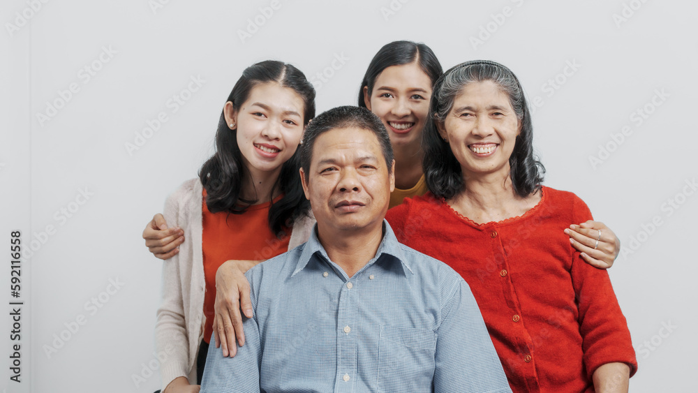 Looking camera, Happy anniversary day family of Elderly father and mother with old sister and young sister real people sitting together on sofa, Do activities together with love happily in the summer Looking camera, Happy anniversary day family of Elderly father and mother with old sister and young sister real people sitting together on sofa, Do activities together with love happily in the summer