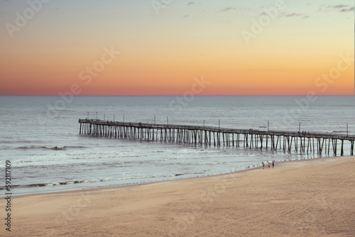 Wooden pier going out into the ocean  on Virginia Beach. 