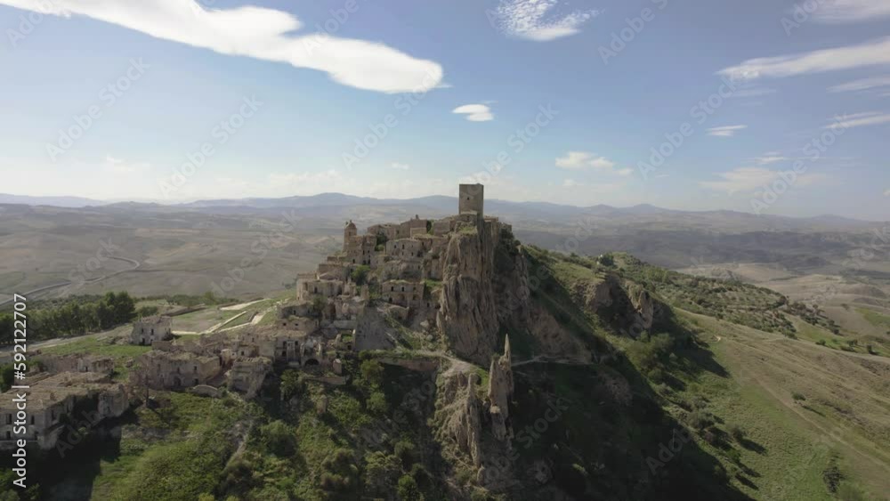 Drone flying slowly and a bit sideways towards the old ruins of Craco on a hill in the south of Italy in 4k Drone flying slowly and a bit sideways towards the old ruins of Craco on a hill in the south of Italy in 4k