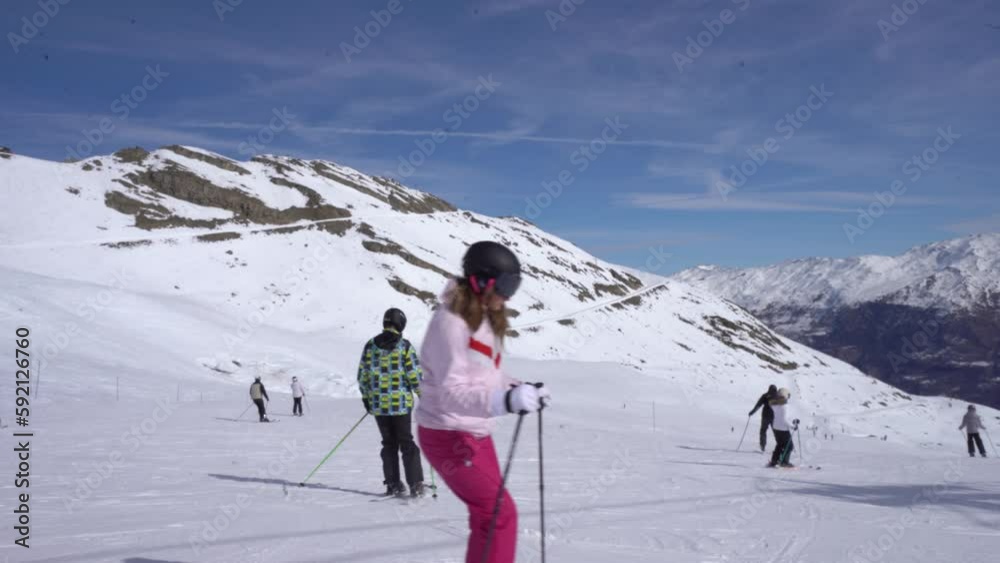 Several Tourists Enjoying Ski Sports During Winter Season. Wide Shot Several Tourists Enjoying Ski Sports During Winter Season. Wide Shot