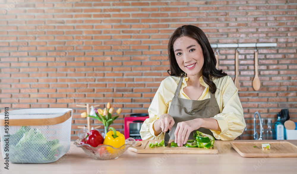 Portrait of asian chef girl cooking vegetable salad chop in kitchen home. New normal work at home lifestyle. Healthy food eco friendly homemade meal, happy do it yourself asian housewife concept