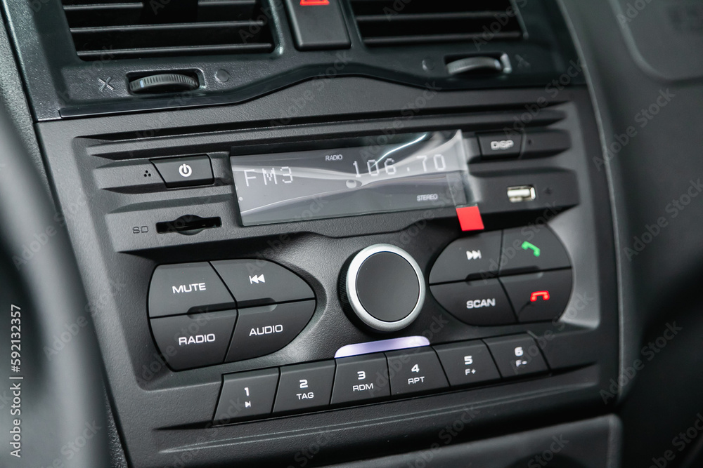 A close up on a black panel with radio, player and control buttons A close up on a black panel with radio, player and control buttons