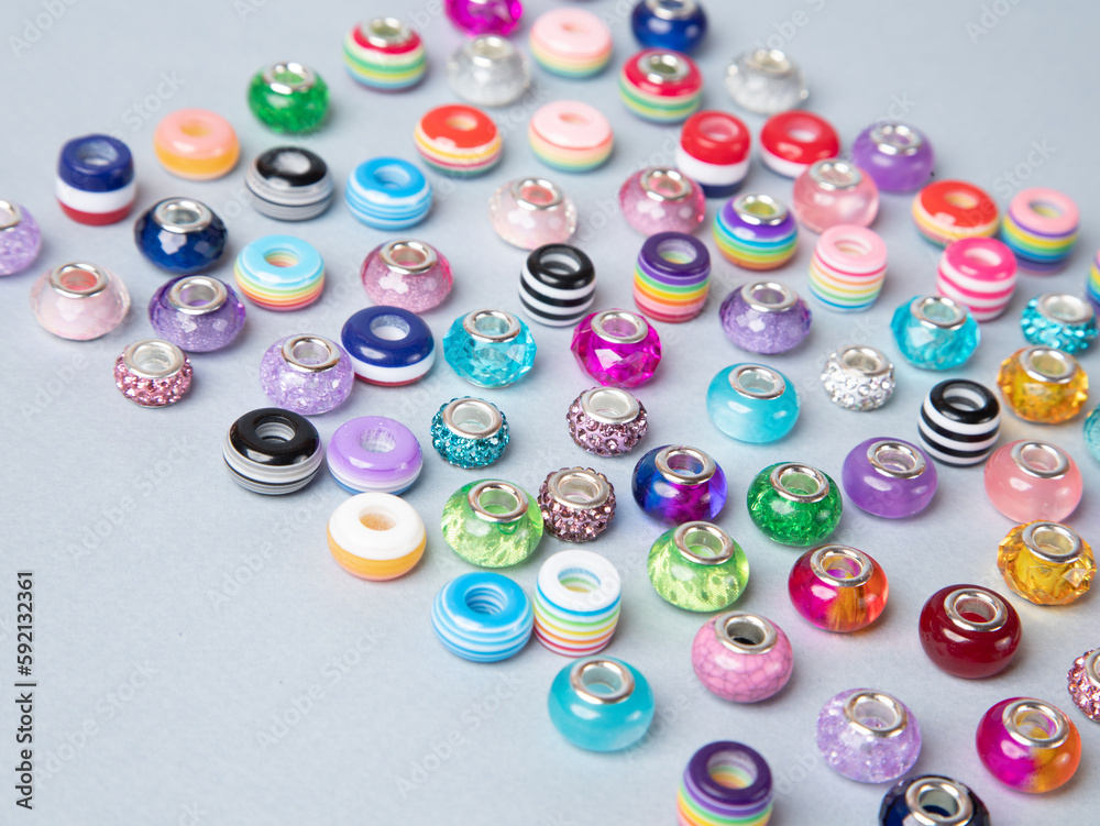 Beads for beautiful handmade rainbow bracelets on blue background. Use for diy beaded jewelry. Beads for beautiful handmade rainbow bracelets on blue background. Use for diy beaded jewelry.