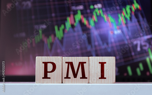 PMI - acronym from wooden blocks with letters, Purchasing Managers Index. Global economy concept photo