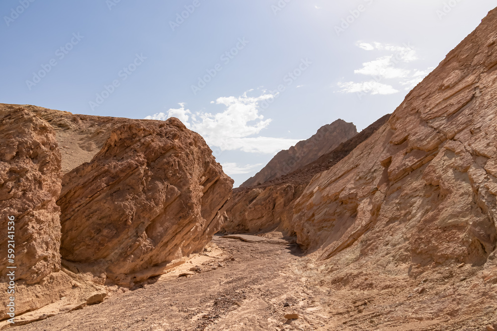 Golden Canyon trailhead with scenic view of colorful geology of multi hued Amargosa Chaos rock formations, Death Valley National Park, Furnace Creek, California, USA. Barren Artist Palette landscape