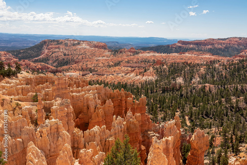 Scenic aerial view of Boat Mesa and massive hoodoo wall sandstone rock formation on Fairyland hiking trail in Bryce Canyon National Park, Utah, USA. Unique nature in barren landscape. Pine tree forest