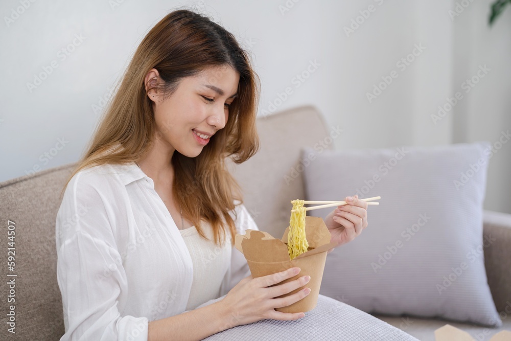 Asian woman with takeaway food and drinks at home. consumption eating home delivery food. enjoying delicious takeaway delivery tasty meal Asian woman with takeaway food and drinks at home. consumption eating home delivery food. enjoying delicious takeaway delivery tasty meal