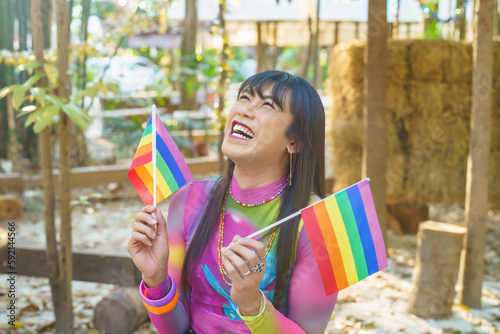Gender Spectrum smiling happy Thai transgender Asian woman with rainbow flag