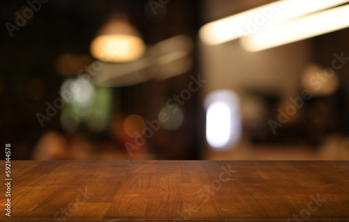 Empty wooden table in front of abstract blurred background of coffee shop . can be used for display or montage your products.Mock up for display of product