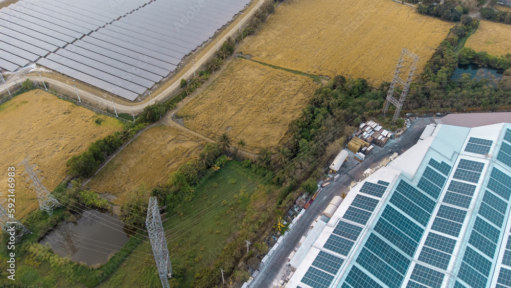 Generate clean energy with solar modules in a large park field in Asia from aerial view by drone. Solar farms for power supply in industrial areas with the concept of green energy with global warmin