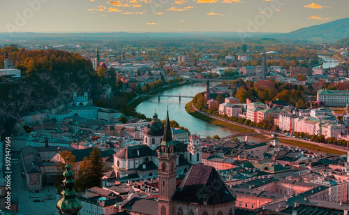The Aerial panoramic view in a Autumn season at a historic city of Salzburg with Salzach river in beautiful golden evening light sky and colorful of autumn at sunset, Salzburger Land, Austria