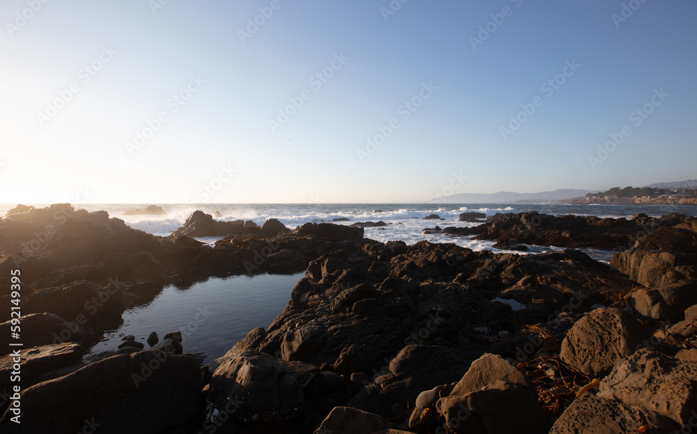 Scenic view of golden hour tide pool on rocky central California coastline during golden hour at Cambria California United States