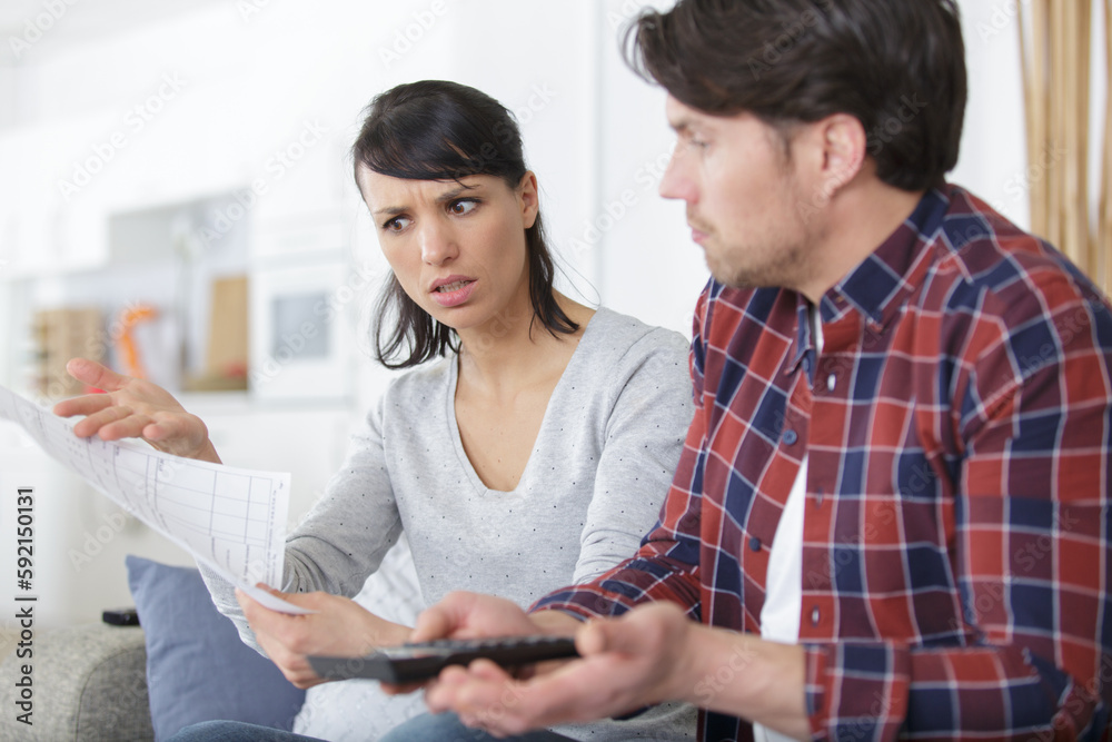 couple arguing while calculating their finances couple arguing while calculating their finances