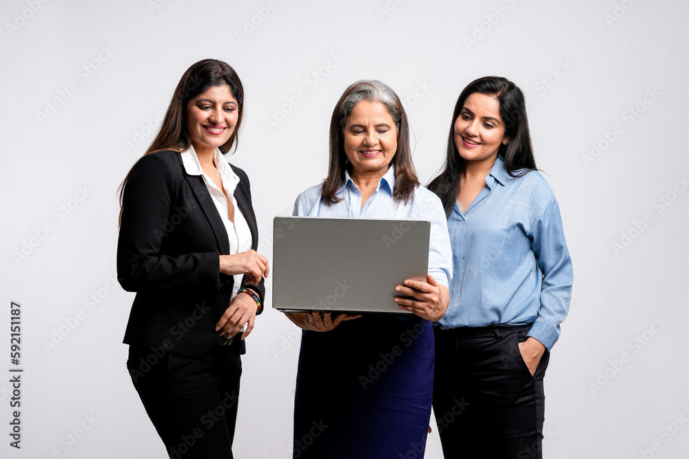 senior female executive showing detail in laptop to his two young colleague. senior female executive showing detail in laptop to his two young colleague.