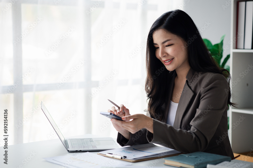 business woman using mobile phone to view data, young Asian women as executives, founding and running start-up executives, young female business leaders. Startup business concept. business woman using mobile phone to view data, young Asian women as executives, founding and running start-up executives, young female business leaders. Startup business concept.