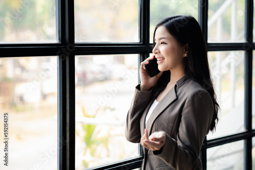 Business woman talking on the phone, young Asian women as executives, founding and running start-up executives, young female business leaders. Startup business concept. Free Download Business woman talking on the phone, young Asian women as executives, founding and running start-up executives, young female business leaders. Startup business concept. - GFXLoad