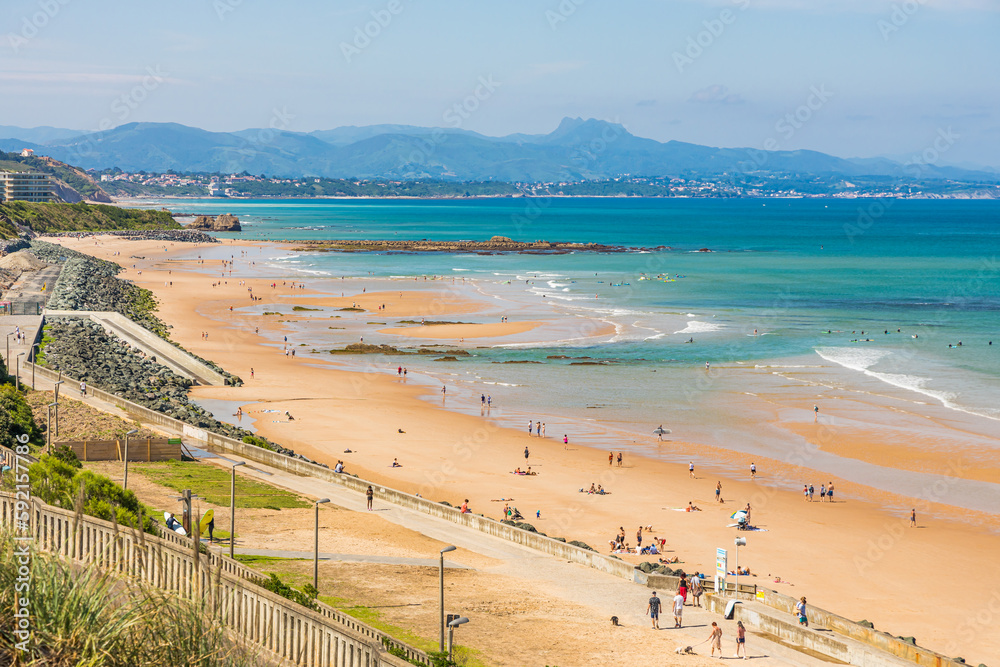 Cote des Basques beach and Pyrenees mountain in the background in Biarritz, France on a summer day Cote des Basques beach and Pyrenees mountain in the background in Biarritz, France on a summer day