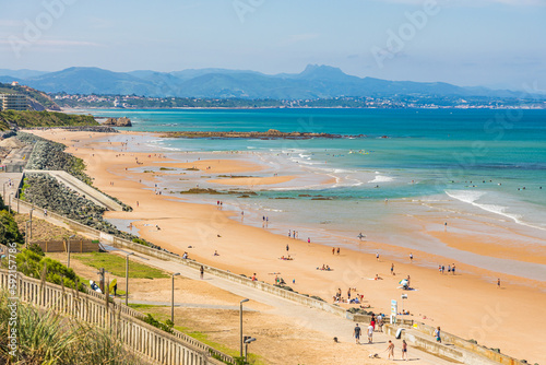 Cote des Basques beach and Pyrenees mountain in the background in Biarritz, France on a summer day photo