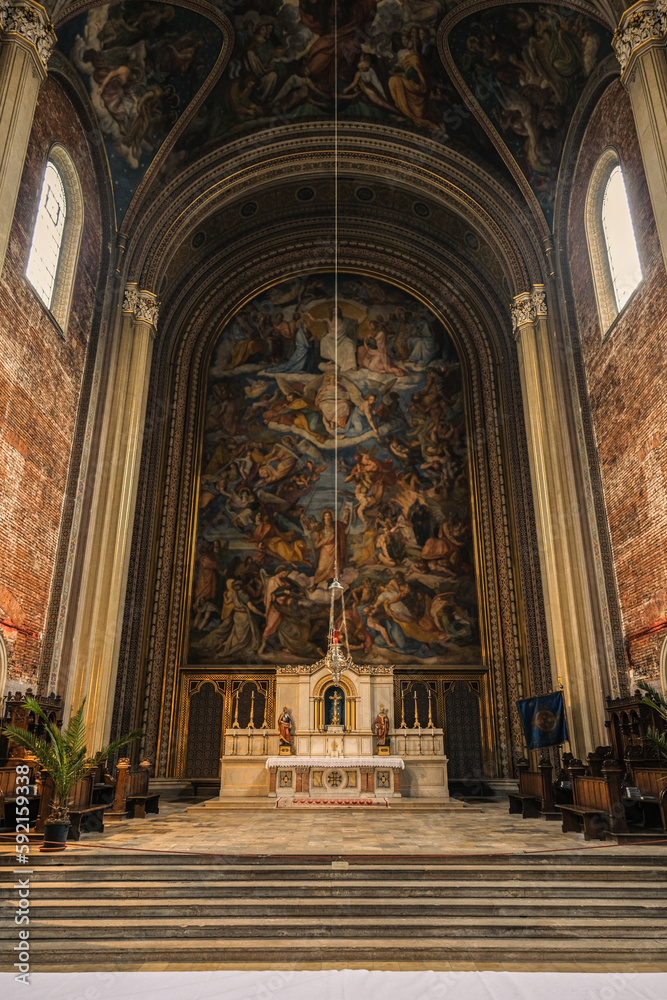 Fototapeta premium Monumental church building in Gothic in neo-romanesque arch style with large ceiling and altar murals and fresco, opulent detailed columns and marble structures