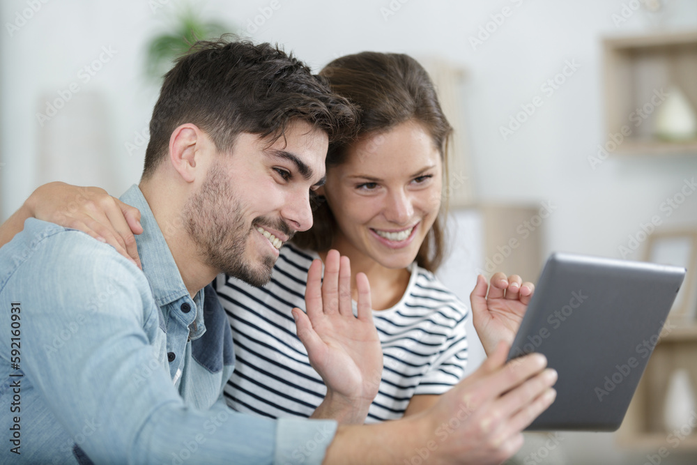 couple cuddling and watching series online on a tablet couple cuddling and watching series online on a tablet