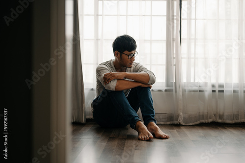 Man sit Depression Dark haired pensive glance Standing by window
