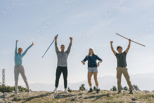 Young happy hiker with their hands up