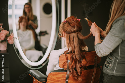 Close up shot of hairdresser brushing client hair