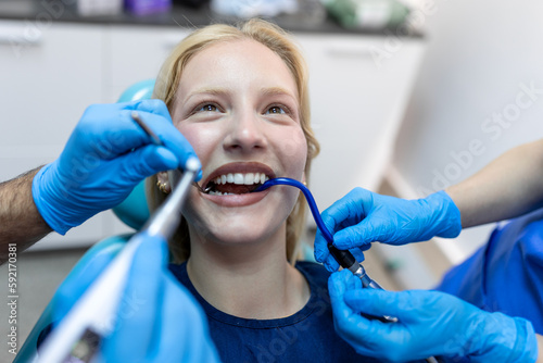 Teeth health concept. Cropped photo of smiling woman mouth under treatment at dental clinic, panorama