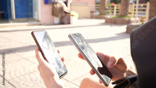 Girl multitasking with two smartphones