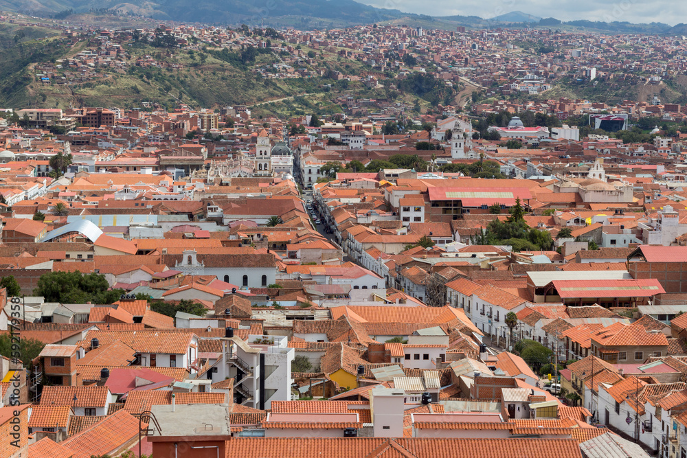 Cityscape of the town of Sucre, Bolivia, with the Andes Mountains in the background.