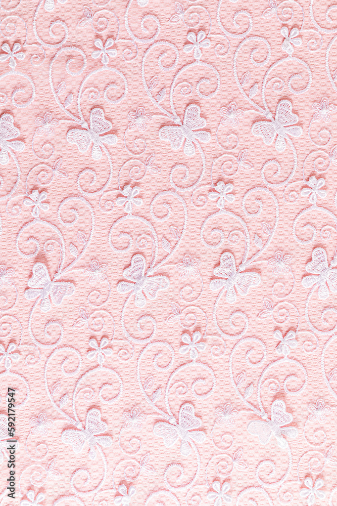 Beautiful delicate lace of white flowers and butterflies on a pink background. wedding background. layout for design. vertical background Beautiful delicate lace of white flowers and butterflies on a pink background. wedding background. layout for design. vertical background