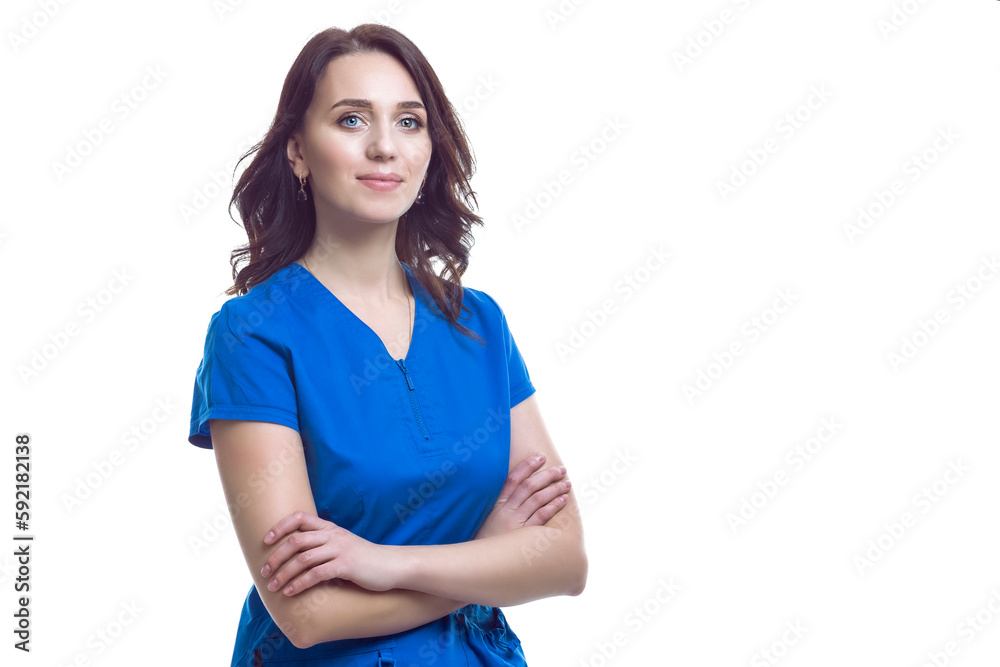 Medical Ideas. Positive Winsome Friendly Female GP Doctor In Blue Smock With Folded hands Isolated Over White background Medical Ideas. Positive Winsome Friendly Female GP Doctor In Blue Smock With Folded hands Isolated Over White background