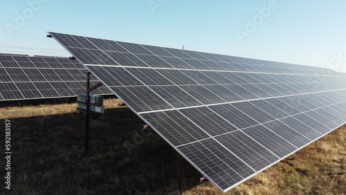 Solar power plant. Flight over modules of solar power station on sunny day. Alternative green electricity power. New modern technology. Renewable electrical energy. photovoltaic modules photobatteries