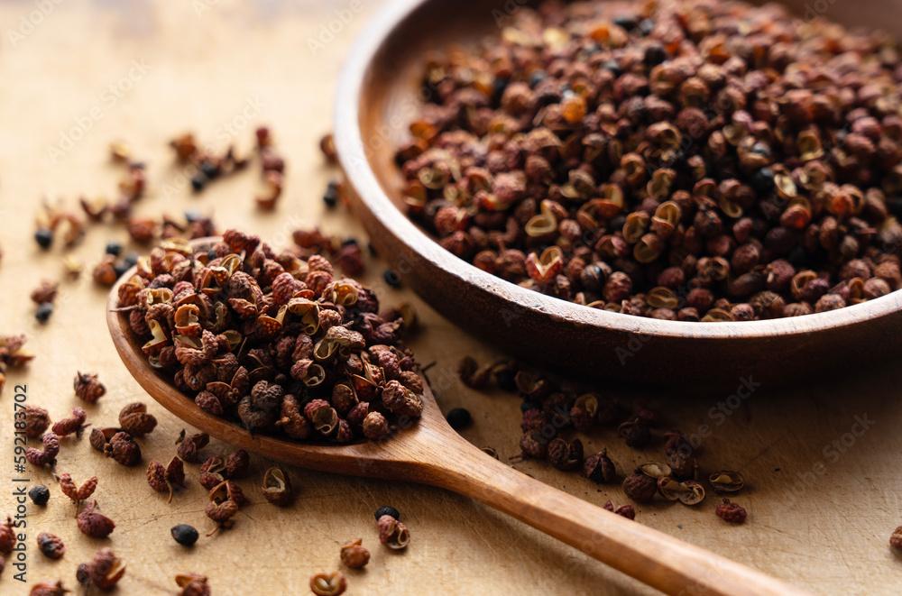 Sichuan pepper and wooden spoon on the table. Sichuan pepper and wooden spoon on the table.