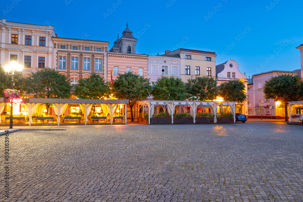 beautiful street restaurants with illuminated and flowers on the market in Leszno at dusk. Poland