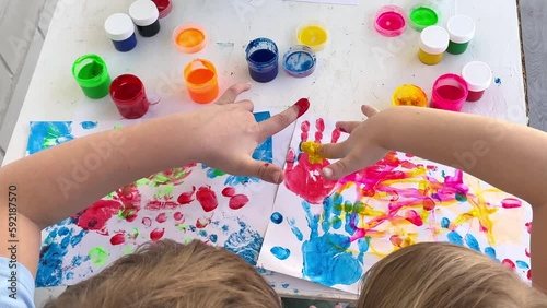 Children paint fingers drawing baby painting hand therapy children art play. Kids have fun and create picture. Palms of different colors. Sensory development and experiences, themed activities with ch