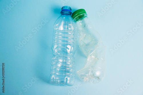 Plastic bottles from drinks on a paper background. Concept of earth day, zero waste and plastic recycling.