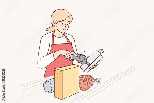 Woman supermarket cashier uses scanner to read barcodes on products of selected shop customers