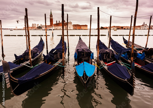 Gondolas in Venice on sunset next to San Marco square. Famous landmark in Italy