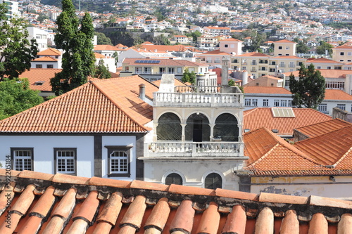 Panoramic view of the old town of Funchal, Madeira island, Portugal with red tile roofs and historical buildings on a sunny day