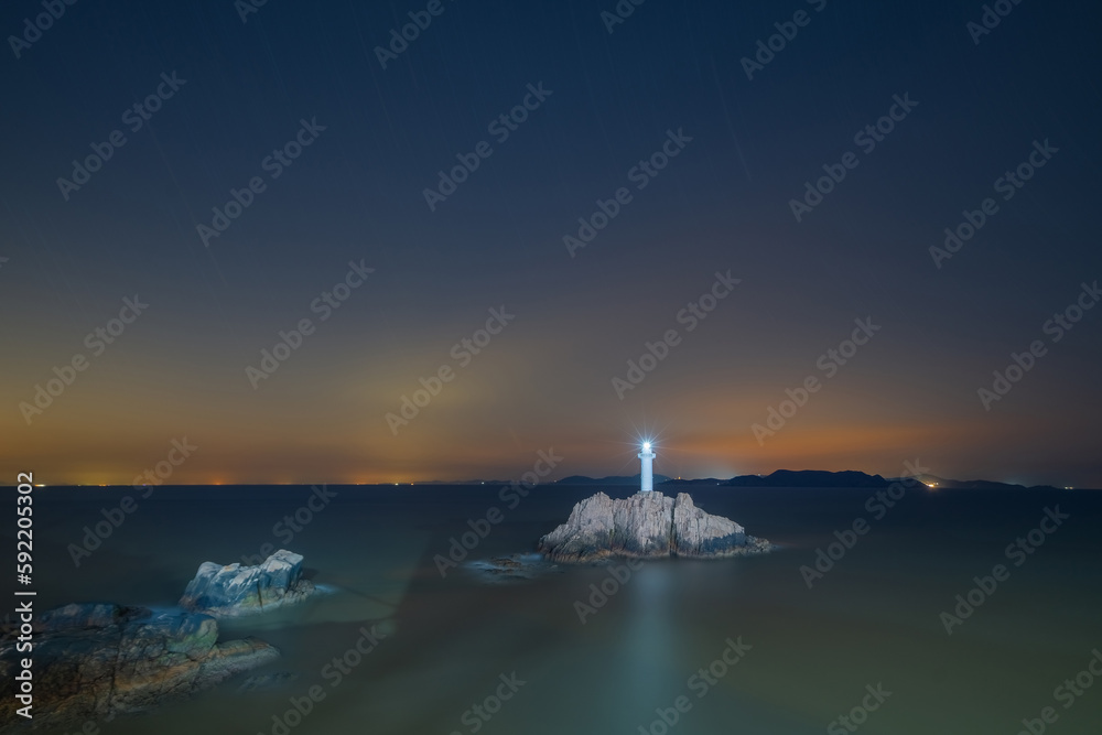 Reefs, lighthouses, and night views at sea on Dongji Island, Zhoushan City, Zhejiang Province, China On April 9, 2023