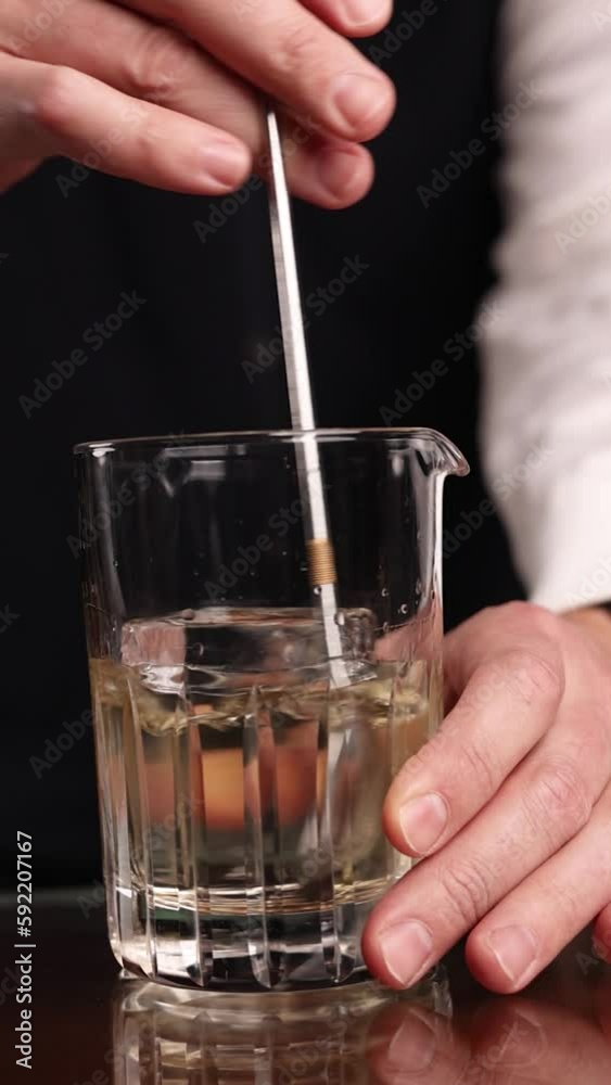the bartender prepares a popular cocktail at the bar
