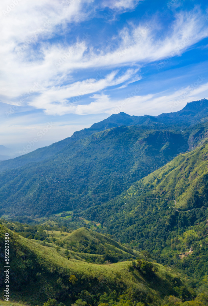 Beautiful mountain tropical landscape with green hills and blue sky. Photography for tourism background, design and advertising.