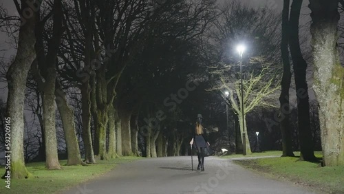 Wallpaper Mural A young female child dressed for Halloween as a plague Doctor walks in between trees at night Torontodigital.ca