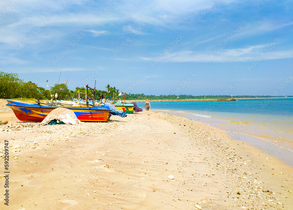 Beautiful tropical landscape with colorful fishing village boats. Photography for tourism background, design and advertising. 10 January 2023, Sooriya, Sri Lanka Beautiful tropical landscape with colorful fishing village boats. Photography for tourism background, design and advertising. 10 January 2023, Sooriya, Sri Lanka