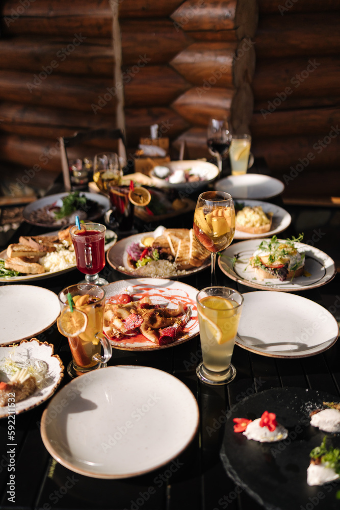 Served table with food and drinks. Restaurant on terrace. Served table with food and drinks. Restaurant on terrace.
