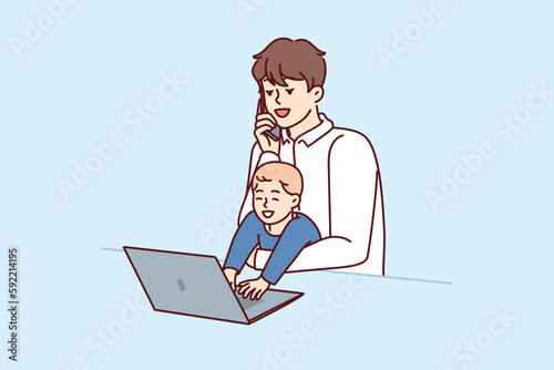 Young father freelancer with baby in arms works with laptop and makes phone call during quarantine restrictions. Father with little boy does remote work and is raising son at same time 